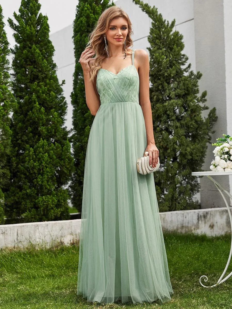 Robe de demoiselle d'honneur sans manches en tulle pailleté avec bretelles croisées dans le dos