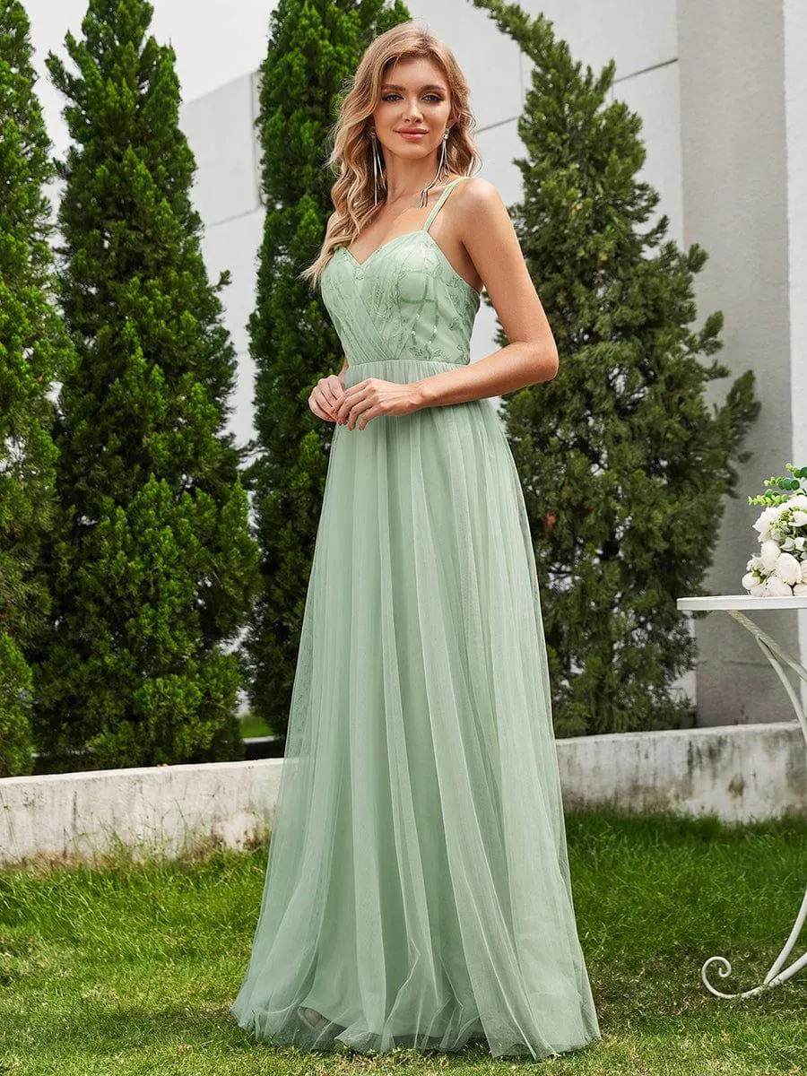 Robe de demoiselle d'honneur sans manches en tulle pailleté avec bretelles croisées dans le dos